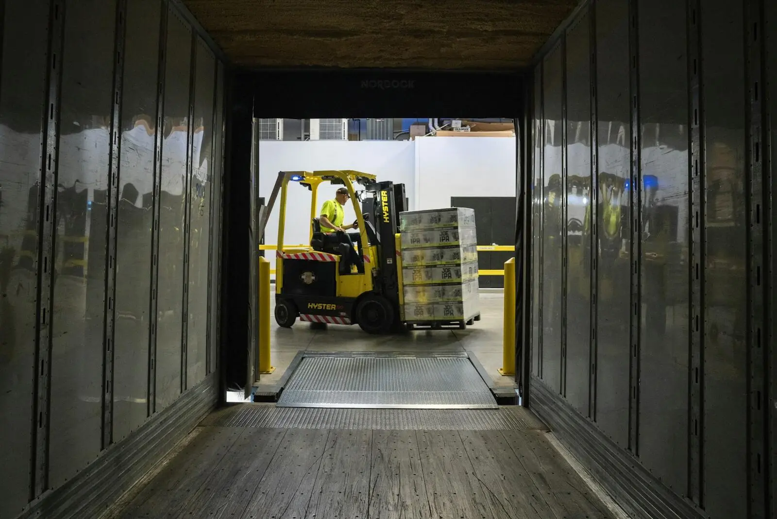 Forklift moving a pallet at a loading dock