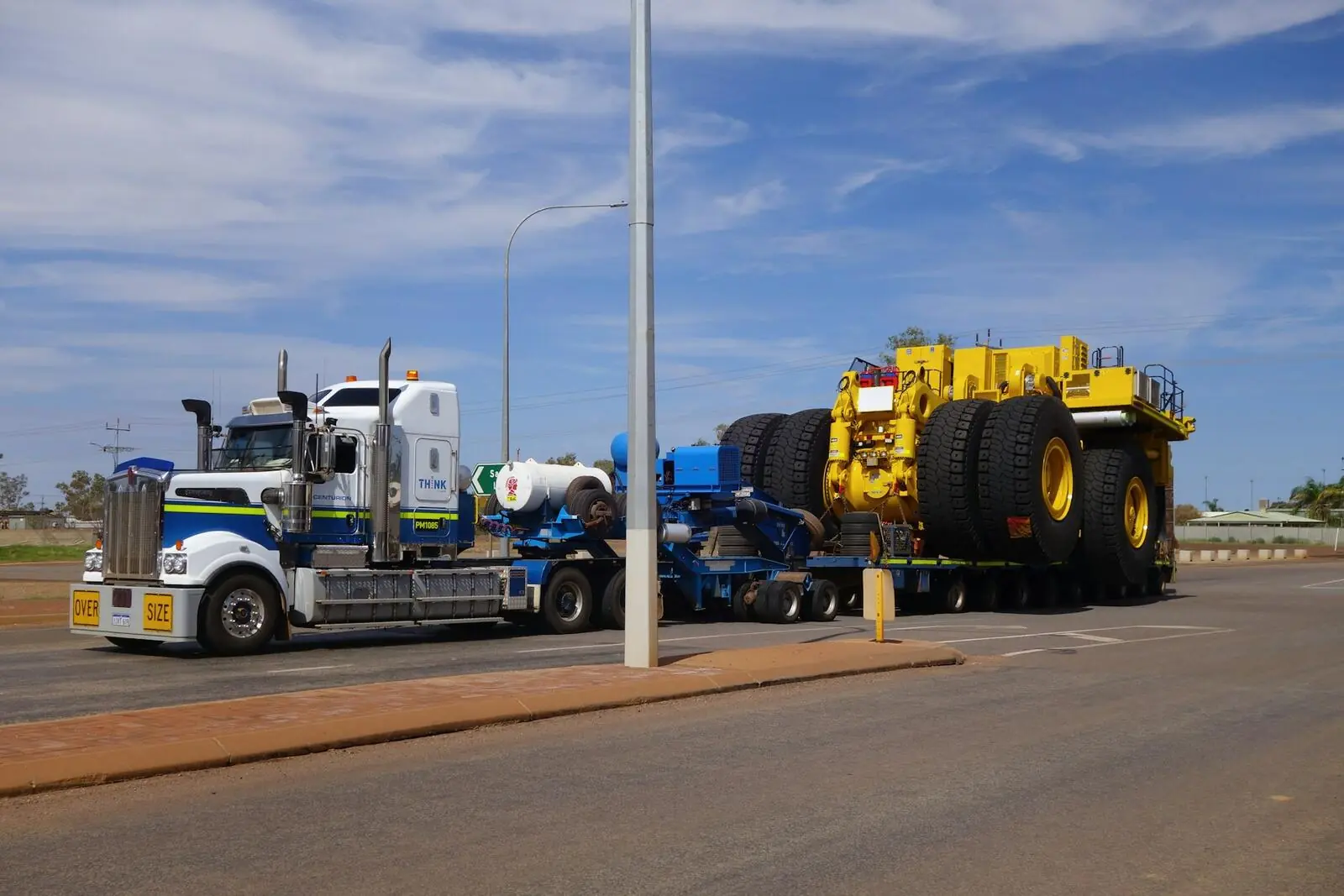 Oversized mining vehicle secured on a lowboy trailer